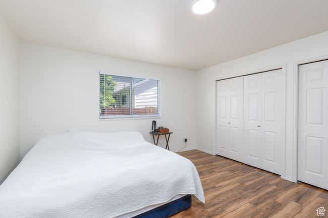 Bedroom featuring wood finished floors and baseboards | Image 11