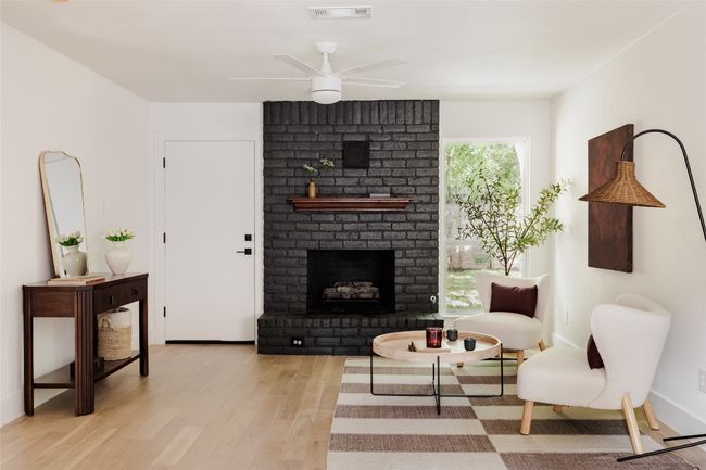 Living area with a fireplace, wood finished floors, and ceiling fan | Image 8