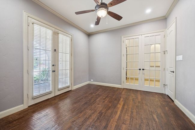 Unfurnished room with french doors, wood finished floors, healthy amount of natural light, crown molding, and ceiling fan | Image 10