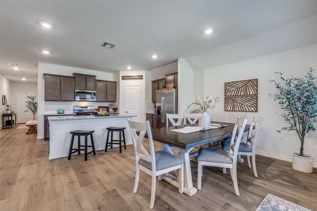 Dining Room View 1 featuring light laminated wood plank flooring, recessed lighting, and baseboards | Image 12