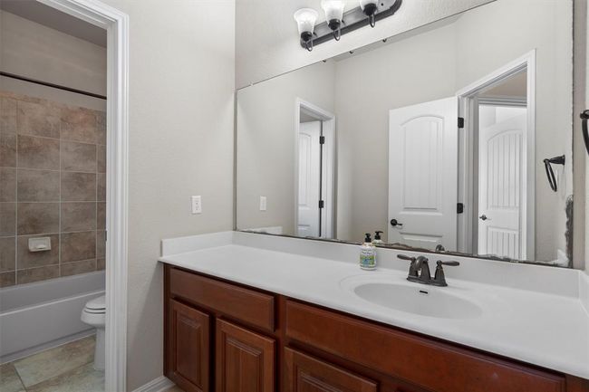 Bathroom featuring toilet, vanity, and shower / bathtub combination | Image 32