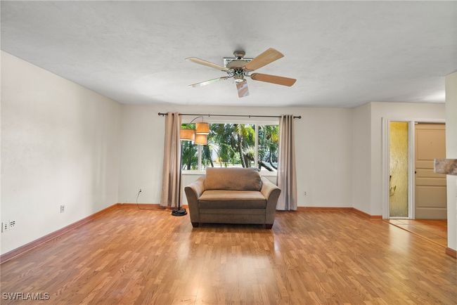 Sitting room with ceiling fan and light wood-type flooring | Image 8