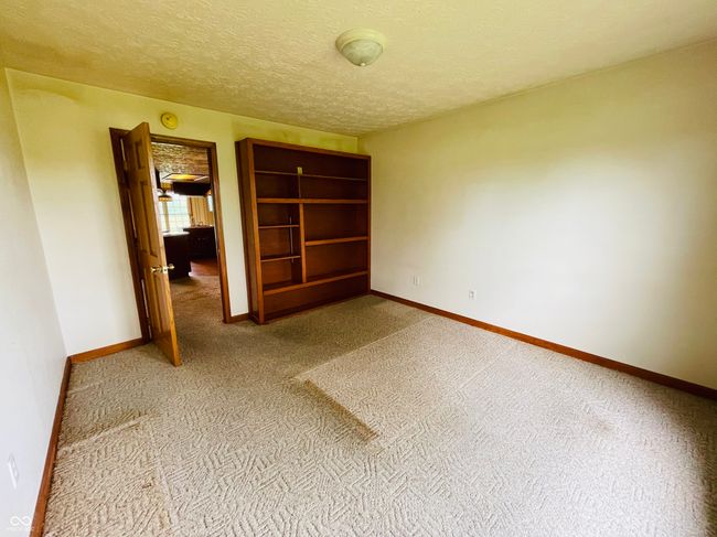 unfurnished room featuring carpet flooring, baseboards, and a textured ceiling | Image 12
