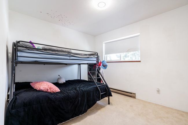 Bedroom featuring a baseboard heating unit and carpet flooring | Image 21