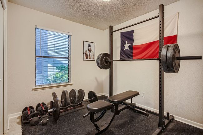 Exercise room with a textured ceiling and baseboards | Image 13