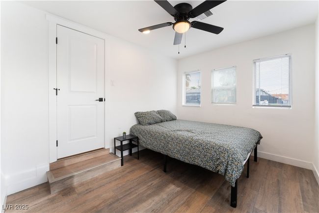Bedroom featuring a ceiling fan, visible vents, baseboards, and wood finished floors | Image 28
