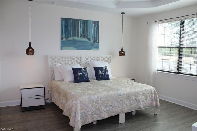Master Bedroom featuring baseboards and wood finished floors | Image 15