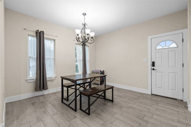 Dining room featuring healthy amount of natural light, a chandelier, and wood finish floors | Image 15