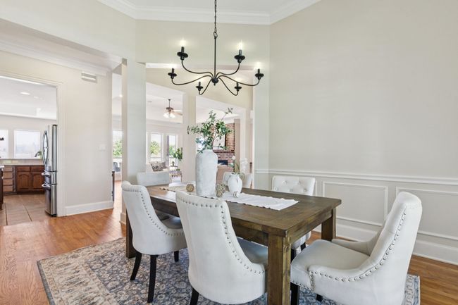 The formal dining space, just off the entry, is open to the living room creating perfect flow for entertaining. There is direct access to the kitchen, but the line of sight does not encompass the food prep area. Out of sight-out of mind! | Image 6