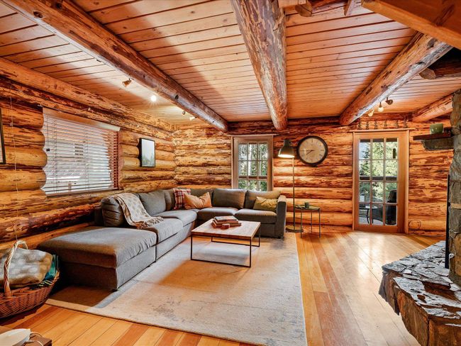 Living area featuring plenty of natural light, hardwood / wood-style floors, and beamed ceiling | Image 14