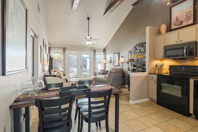 Kitchen featuring tasteful backsplash, french doors, a ceiling fan, and black appliances | Image 17