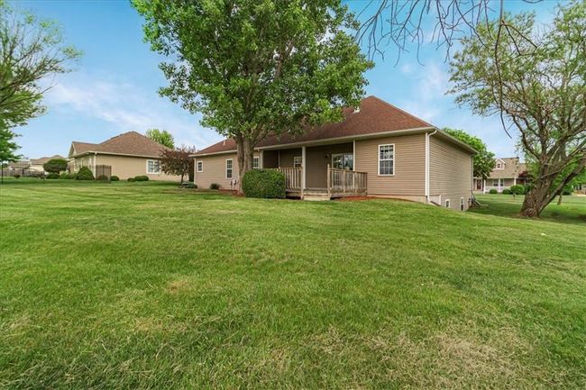 Rear view of property with a lawn and a deck | Image 6