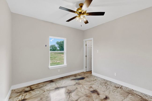 Unfurnished room with baseboards and a ceiling fan | Image 35