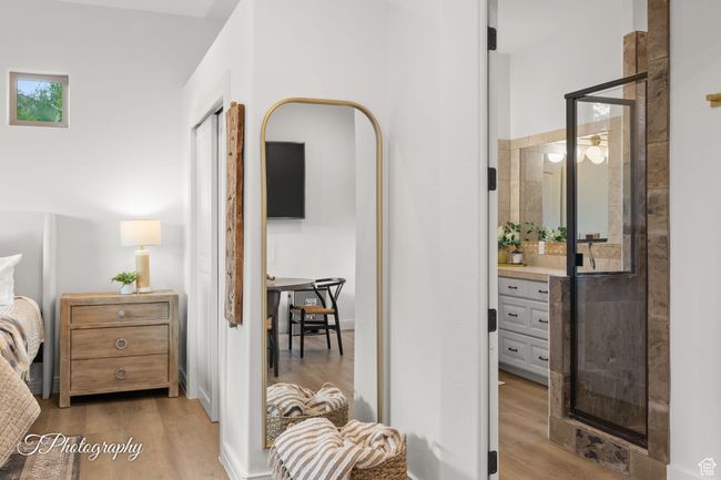 Bedroom featuring wood finished floors and a bar | Image 35