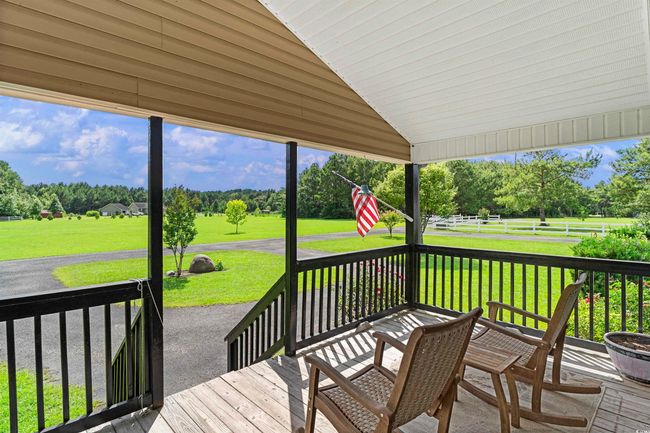 Wooden deck featuring view of wooded area | Image 38