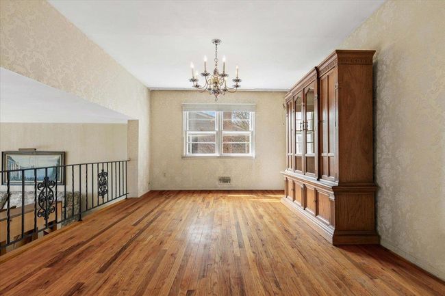 Unfurnished dining area featuring a notable chandelier and wood-type flooring | Image 8