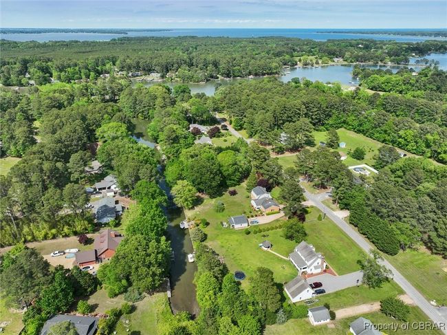 Aerial overview of property's location with a nearby body of water and a forest | Image 41