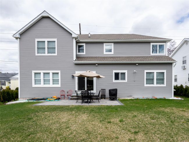 Back of property with a yard, a patio area, and a shingled roof | Image 24