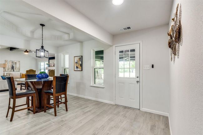 Dining area featuring light wood finished floors and beamed ceiling | Image 13