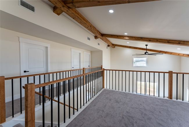 Hall with lofted ceiling with beams, carpet, visible vents, and recessed lighting | Image 15