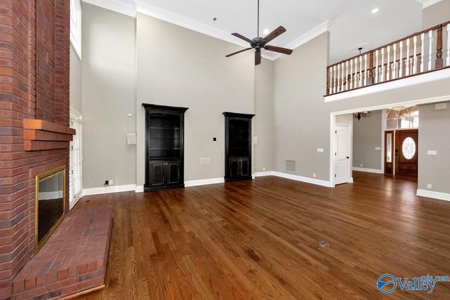 Wood flooring, built in cabinetry, fireplace, extra high ceilings, recessed lighting, crown molding, Double doors open to enclosed porch | Image 7