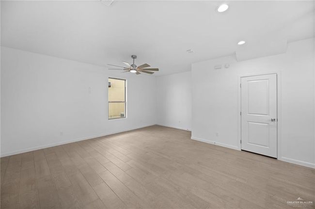Unfurnished room with ceiling fan, light wood-style floors, and recessed lighting | Image 11