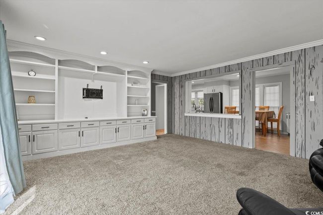 Carpeted living room featuring wallpapered walls, crown molding, and recessed lighting | Image 13