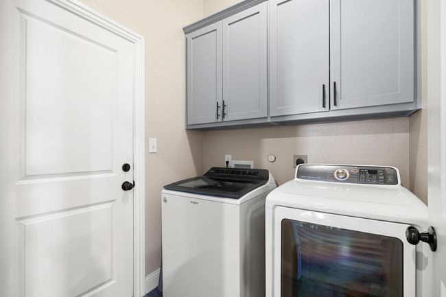 Washroom featuring washer and dryer and cabinet space | Image 30
