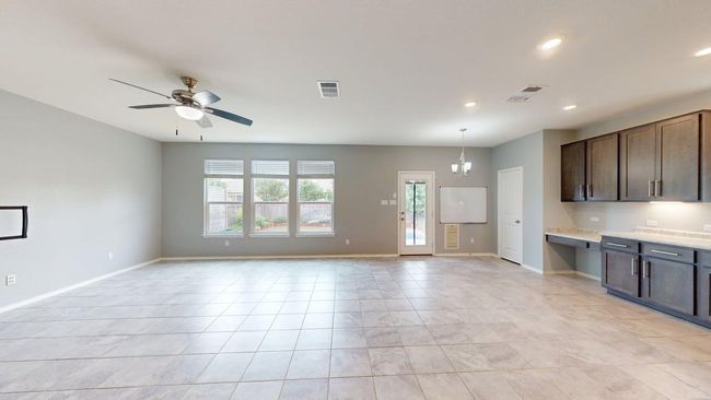 Kitchen featuring visible vents, open floor plan, recessed lighting, and light countertops | Image 13