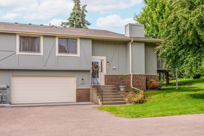Clean architectural lines and neutral tones give this home timeless curb appeal, while the manicured landscape adds to its move-in ready charm. | Image 32