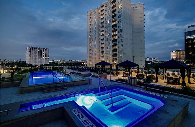 Community pool with a gazebo, a hot tub, and a city view | Image 4