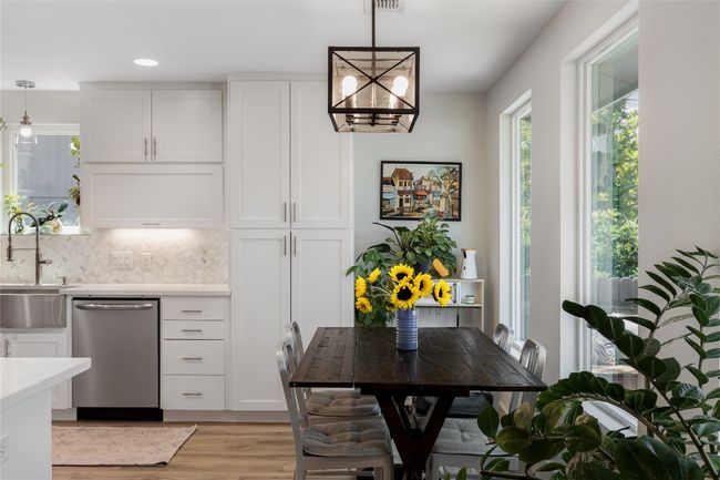 Charming dining nook enjoys backyard views. | Image 17