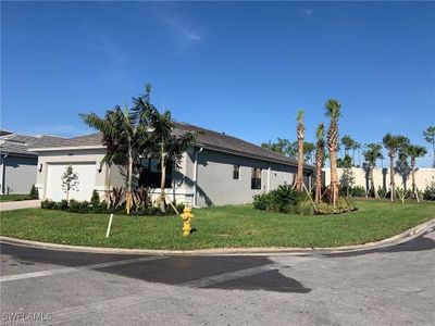 View of side of property with a lawn and a garage | Image 2