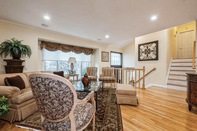 Living area with ornamental molding, baseboards, light wood-style floors, and recessed lighting | Image 4