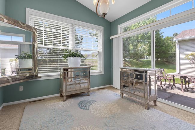 Sunroom has fabulous, vaulted ceiling, windows that allow the natural light to pour in, and wonderful view of your patio. | Image 4