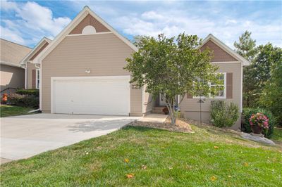 View of front of home with a front lawn and a garage | Image 1