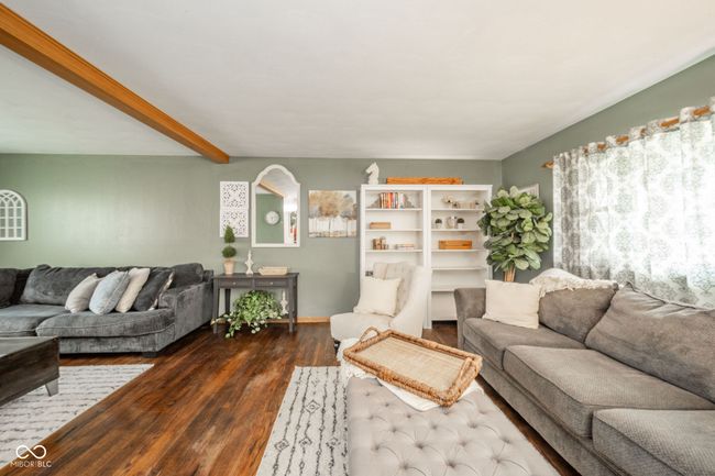 living area with beamed ceiling and wood finished floors | Image 36