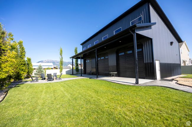 Rear view of pool house with a mountain view, a patio | Image 79