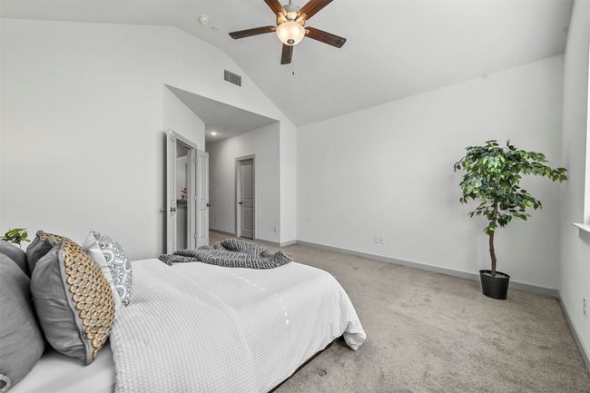 Carpeted bedroom with ceiling fan and vaulted ceiling | Image 22