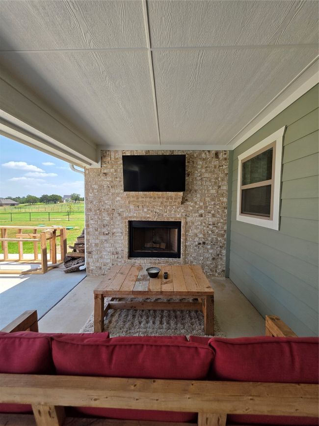 View of patio with an outdoor living space with a fireplace | Image 35