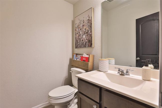 A half bath featuring beautifully finished painted doors that create a striking natural contrast. | Image 14