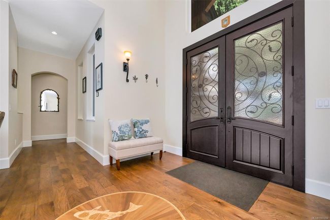 Foyer entrance featuring wood finished floors, french doors, and arched walkways | Image 69