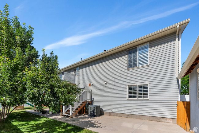 Rear view of property featuring a patio, stairway, and a lawn | Image 29