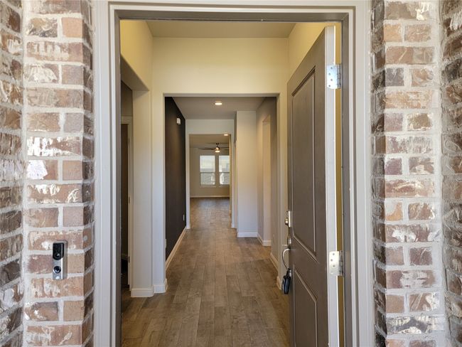 Hall featuring wood finished floors and baseboards | Image 4