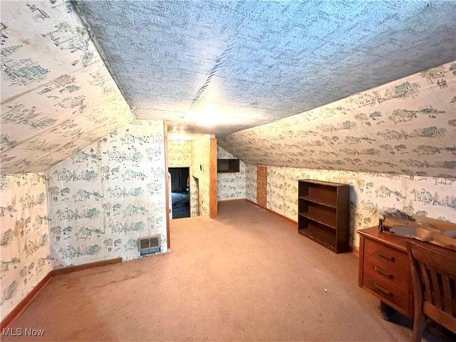 Bonus room with vaulted ceiling, carpet floors, wallpapered walls, and baseboards | Image 21