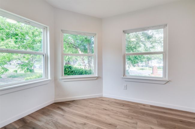 Spare room featuring baseboards and wood finished floors | Image 13