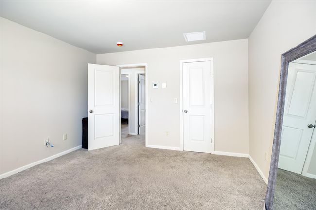 Unfurnished bedroom featuring carpet floors, visible vents, and baseboards | Image 19