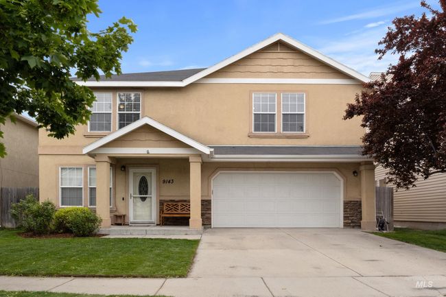 View of front of house featuring an attached garage, stone siding, stucco siding, and driveway | Image 34