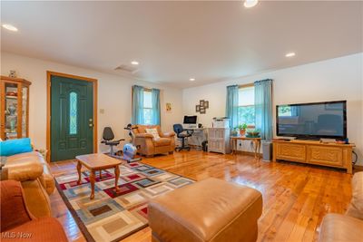 Living room with light wood-type flooring and plenty of natural light | Image 3