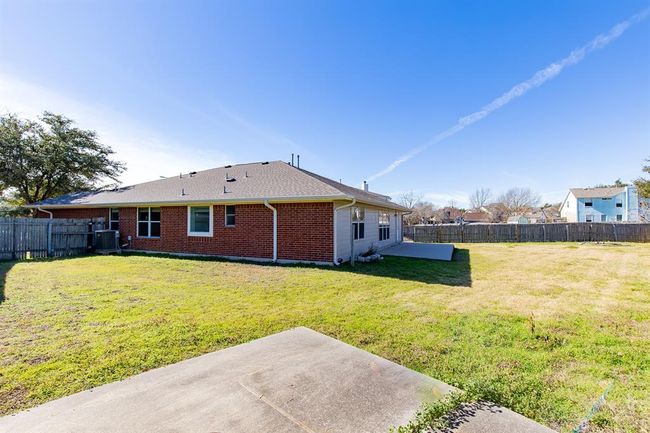 Rear view of property featuring a patio, a fenced backyard, and brick siding | Image 28